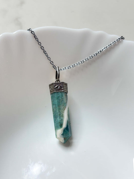Jade stone pendant symbolizing wisdom and harmony, crafted from 100% organic source, enhances intuition and protection.